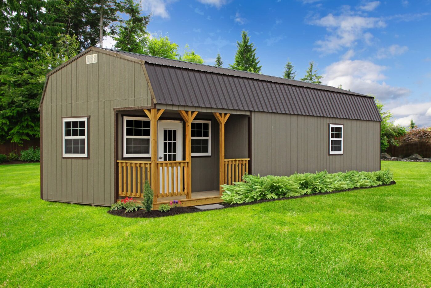 a greenish-grey portable cabin shed with a dark grey metal roof and a porch on the side for sale in imboden AR