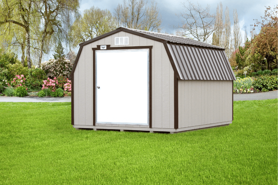 a grey portable minibarn shed with dark grey trim, a dark grey metal roof, and a white door for sale in bald knob AR